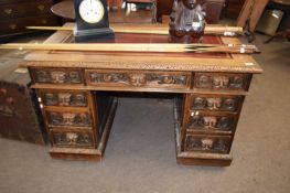 Victorian gothic carved oak twinned pedestal desk with red leather inset top, 23 cm wide