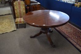 19th Century Danish mahogany pedestal dining table with a circular top over a base with fluted