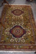 20th Century Middle Eastern wool floor rug decorated with large central lozenges, stylised floral