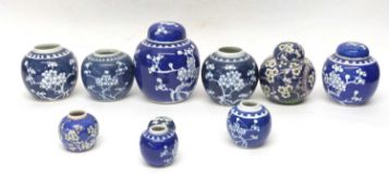Quantity of Chinese porcelain jars and covers all decorated with prunus on blue ground, some