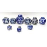 Quantity of Chinese porcelain jars and covers all decorated with prunus on blue ground, some