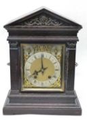Mantel clock late 19th Century in oak case , with gilt spandrels and enamel dial