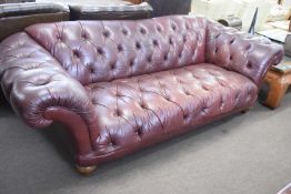 Large 20th century dark brown leather buttoned Chesterfield style sofa on turned wooden legs,