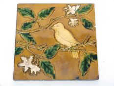 Minton & Hollins tile, the brown ground decorated with majolica type glazes with a bird on a branch