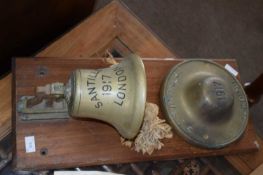 Shipping interest, a brass ships bell marked Santille 1917, London, mounted on a hardwood back, 68