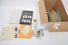 Box containing quantity of postcards and albums and valuation book for cigarette cards