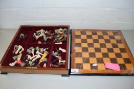 MODERN LAQUERED CHESS BOARD TOGETHER WITH VARIOUS RESIN PIECES TO INCLUDE FIGURAL DESIGNS
