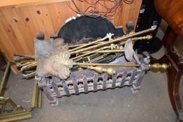 CAST IRON FIRE GRATE TOGETHER WITH A QUANTITY OF VARIOUS BRASS FIRE TOOLS