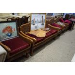 FAR EASTERN HARDWOOD LOUNGE SUITE COMPRISING A THREE SEATER SOFA AND FOUR ARMCHAIRS ALL DECORATED