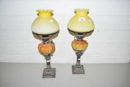 UNUSUAL PAIR OF SMALL OIL LAMPS WITH SILVER PLATED BASES, OPAQUE GLASS FONTS AND FRILLED YELLOW