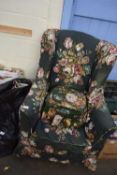 FLORAL UPHOLSTERED WING BACK ARMCHAIR AND ACCOMPANYING FOOTSTOOL