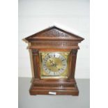 EARLY 20TH CENTURY MANTEL OR BRACKET CLOCK SET IN A HARDWOOD ARCHITECTURAL CASE