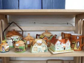 MIXED LOT: VARIOUS COTTAGE FORMED TEAPOTS, CHEESE DISH, MONEY BOX ETC TO INCLUDE BESWICK AND OTHERS