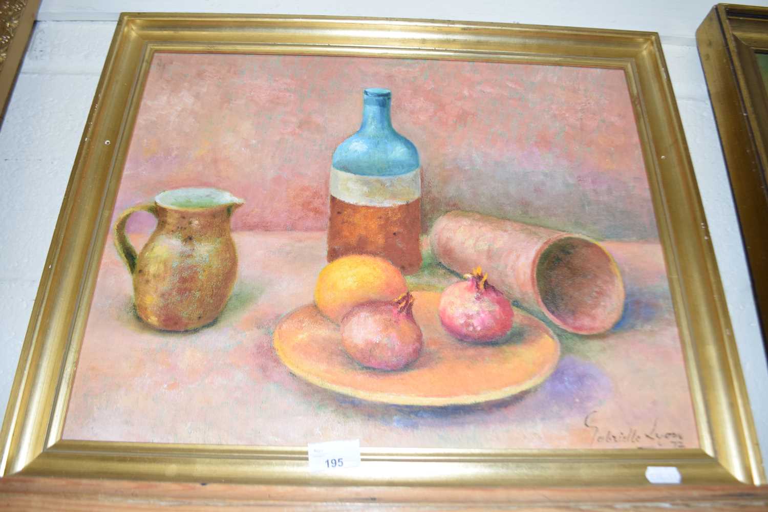 GABRIELLE LYON STILL LIFE STUDY OF POMEGRANATES AND ITEMS ON A TABLE, OIL ON BOARD, GILT FRAMED
