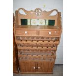 PINE TILE BACK SIDE CABINET WITH INTEGRAL WINE RACKS AND COVERED BASE