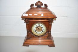 LATE 19TH/EARLY 20TH CENTURY MANTEL CLOCK IN ARCHITECTURAL HARDWOOD CASE