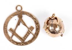 9ct gold framed masonic ball pendant, opening to a gilt line articulated cross interior, together