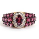 Modern 9ct gold pink stone and diamond ring, the centre pink stone raised within a small diamond