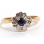 18ct gold sapphire and diamond cluster ring the central round faceted sapphire raised between