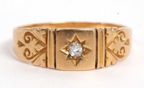 18ct gold and diamond ring centering a small old cut diamond in an engraved setting, between