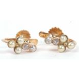 Pair of diamond and seed pearl cluster earrings having three small seed pearls and highlighted