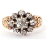 Diamond cluster ring centering an old cushion cut diamond surrounded by seven small old cut diamonds