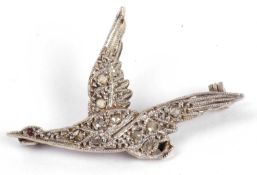Precious metal diamond bird brooch, the bird in flight and set throughout with small rose cut