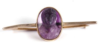 Oval carved amethyst head of a young woman front facing in high relief, applied to a gilt metal