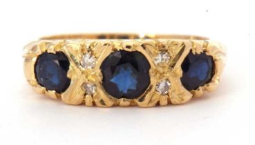 18ct gold sapphire and diamond ring featuring three graduated round cut faceted sapphires