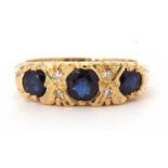 18ct gold sapphire and diamond ring featuring three graduated round cut faceted sapphires