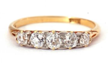 Five stone diamond ring featuring five graduated old cut diamonds individually claw set in a