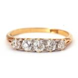 Five stone diamond ring featuring five graduated old cut diamonds individually claw set in a