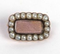 Antique mourning brooch, the vacant glazed central panel set within a small seed pearl surround,