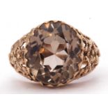 9ct gold quartz dress ring the oval faceted quartz raised between ornate floral pierced shoulders,