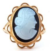 9ct gold glass cameo ring depicting a profile of a lady, bezel set in a beaded and scroll mount,