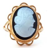 9ct gold glass cameo ring depicting a profile of a lady, bezel set in a beaded and scroll mount,