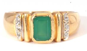 Modern green and white stone set ring featuring a central rectangular cut green stone in rub-over