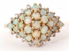 Modern 9ct gold, opal and diamond cluster ring, designed with five tiers of small graduated opals,
