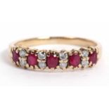 Small 9ct gold ruby and diamond ring featuring five small round cut rubies highlighted between