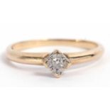 9ct gold single stone diamond ring featuring a small diamond in illusion setting, raised between
