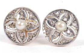 Pair of diamond and pearl stud earrings, each pair circular plaque centering a small seed pearl