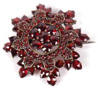 Vintage bohemian style garnet set starburst brooch, 30mm diameter