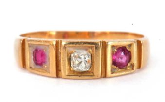 Antique 18ct gold diamond and ruby three stone ring featuring an old cut diamond flanked by two