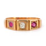 Antique 18ct gold diamond and ruby three stone ring featuring an old cut diamond flanked by two