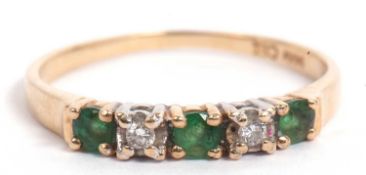 Modern emerald and diamond ring, line set with three small emeralds and two small diamonds,
