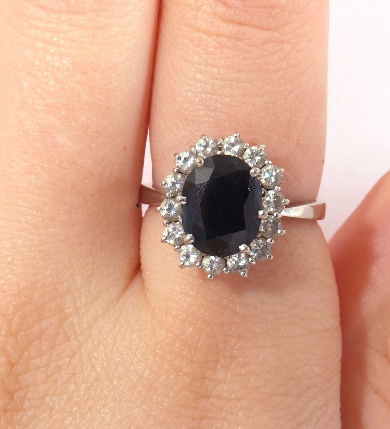 18ct white gold, dark sapphire and diamond ring, the oval faceted sapphire is 10x8mm, raised above a - Image 8 of 8