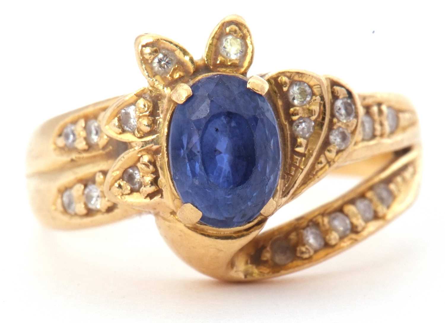 Sapphire and diamond designer ring, the oval shaped faceted sapphire four claw set between small