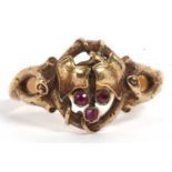 Mid grade yellow metal and ruby ring, an open work ivy leaf and branch design highlighted with three
