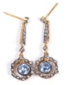 Pair of pale sapphire and diamond drop earrings, each circular sapphire suspended in a small old cut