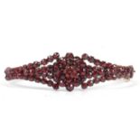 Vintage bohemian style garnet hinge bracelet, the top section having an open work cluster design,